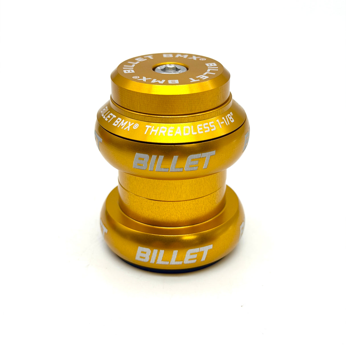 A gold anodized metal bicycle headset from Billet BMX, featuring white printed branding and text, shown on a clean white background.