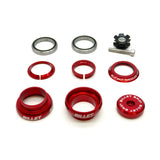 An 8-piece bicycle headset bearing and spacer kit, featuring red anodized aluminum components, silver steel bearings, and a black star-shaped lock nut, laid out on a white background. The components feature the 'BILLET' brand name printed in white.